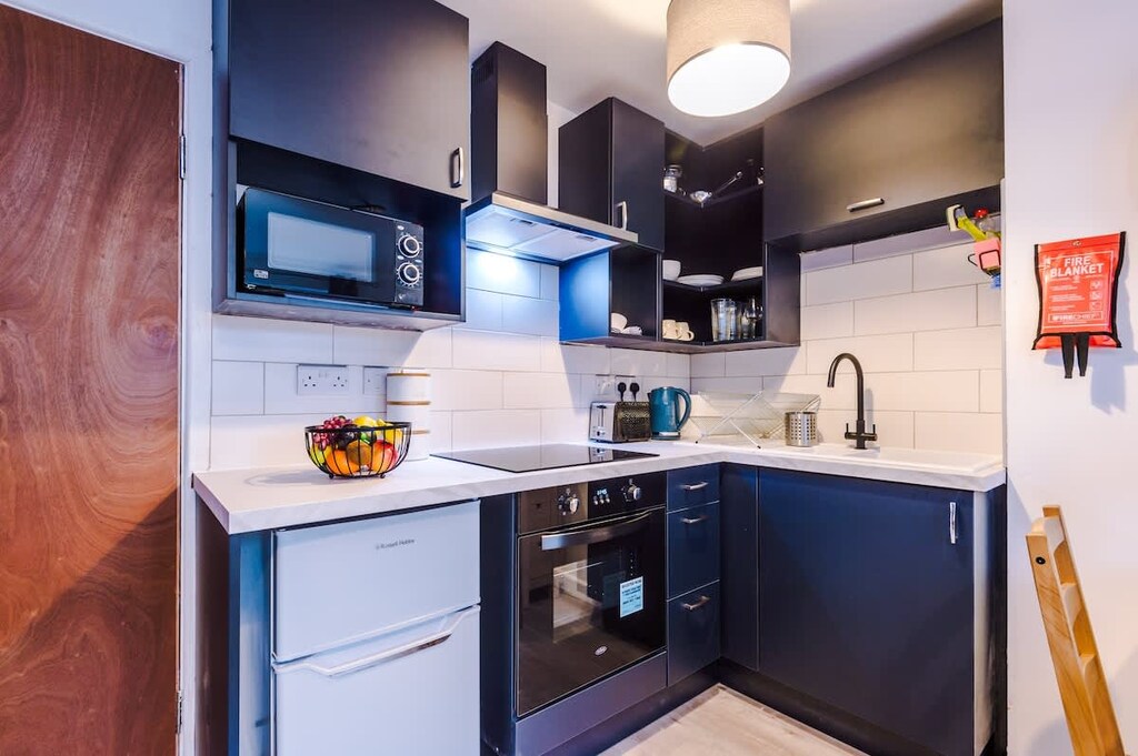 The open plan living room benefits from a double sofa bed, 4 seater dining table and fully equipped kitchen.