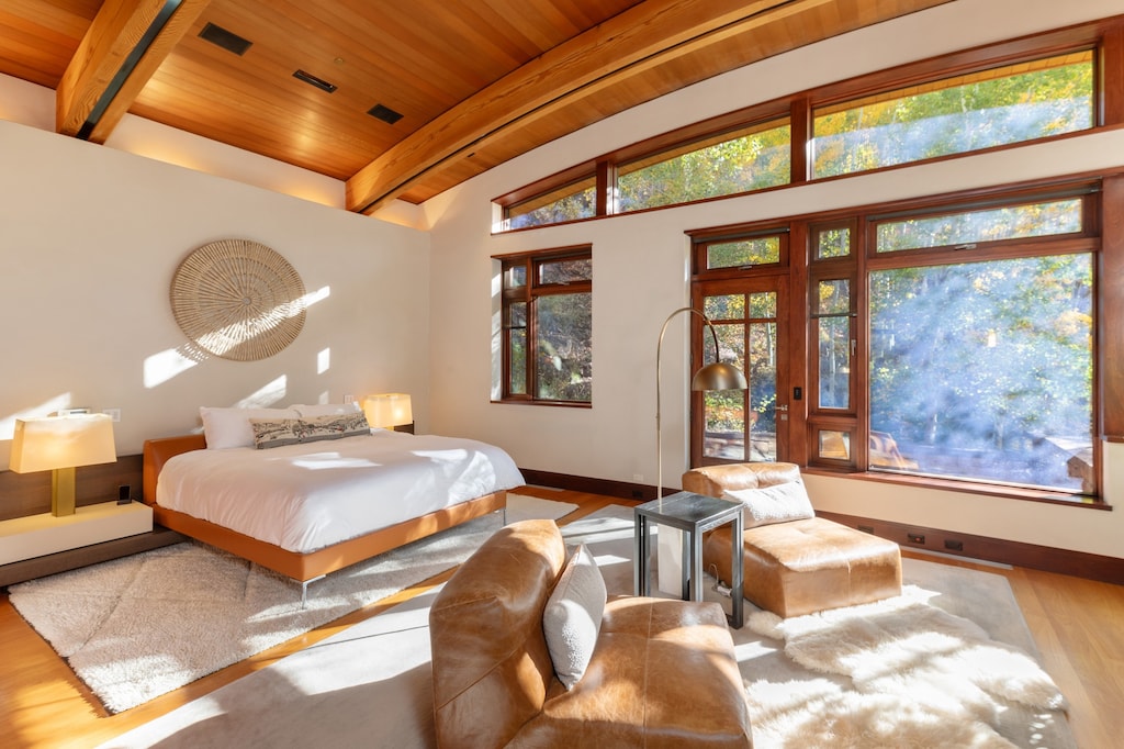 Primary Suite: A serene sanctuary with king bed, a flat-screen TV, and fireplace.