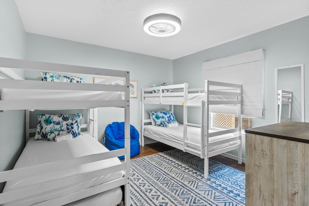 Radiant Bedroom #4 has 2 twin/twin bunks and a mounted flat-screen TV.