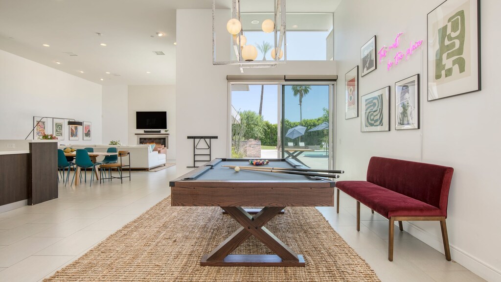 Pool table surrounded by natural light indoors. (Polo Villa 1)