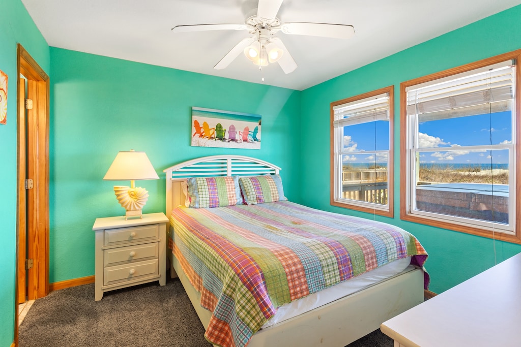 Retreat to the mid-level queen bedroom with ocean views.