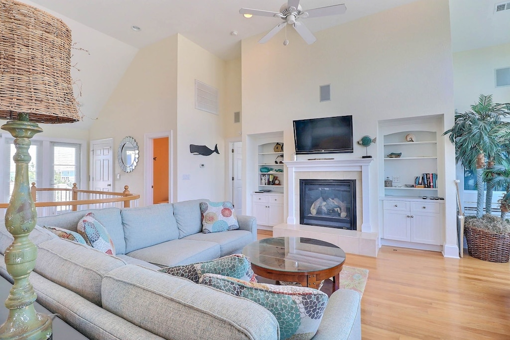 In the central living area, turn on the gas fireplace and enjoy movie night on the comfy couch or simply relax and bask in the sunshine as it filters in through several large windows.