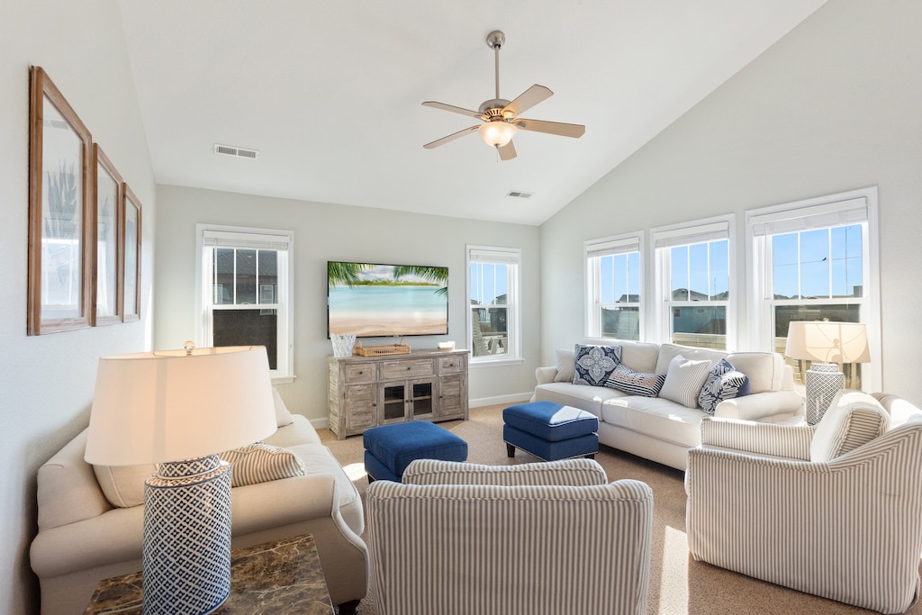 The Top-Level open-concept design features a bright and inviting Living Area with high ceilings and plenty of natural light.