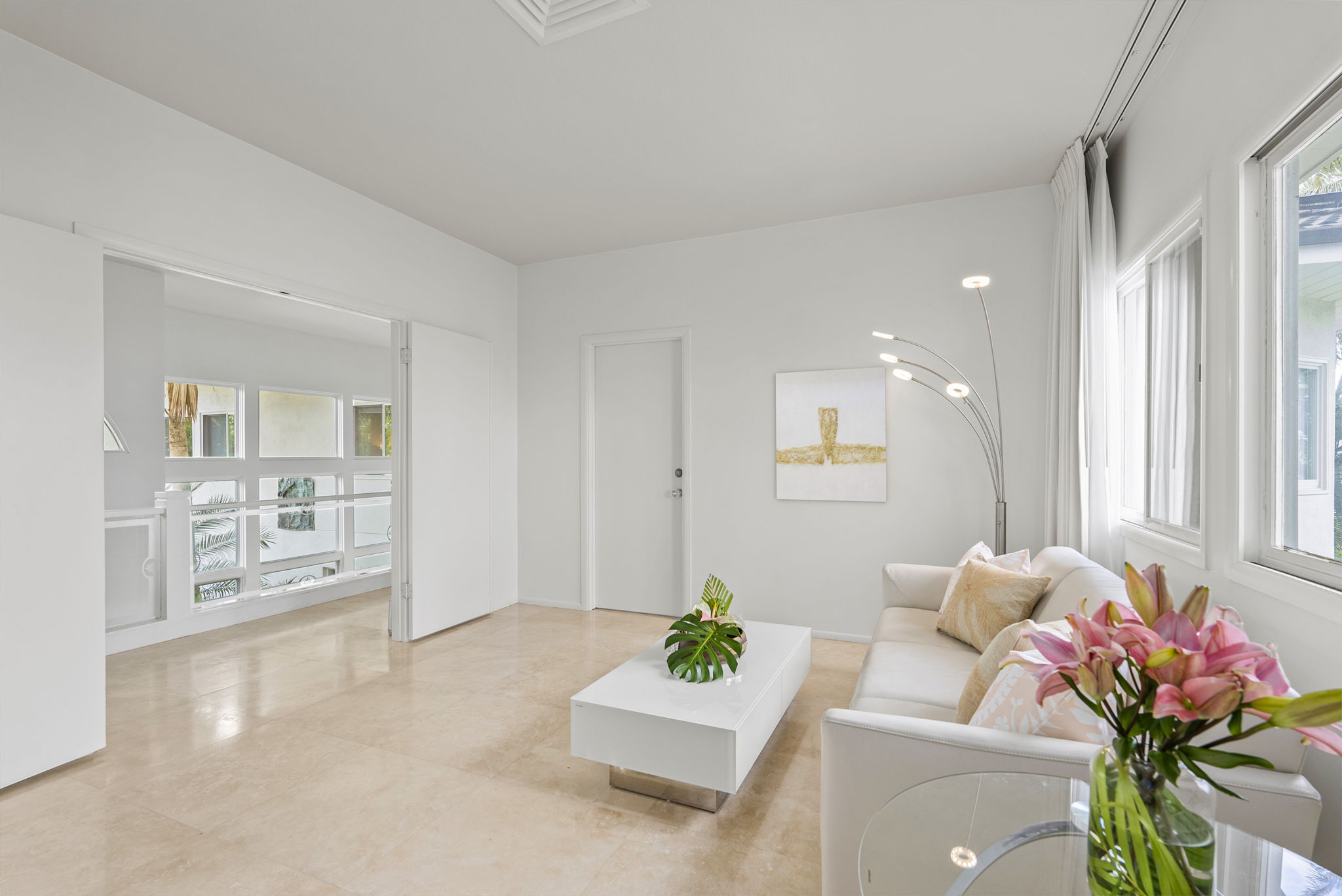 A guest lounge filled with coastal tones and plush seating—ideal for private conversations or downtime away from the group.