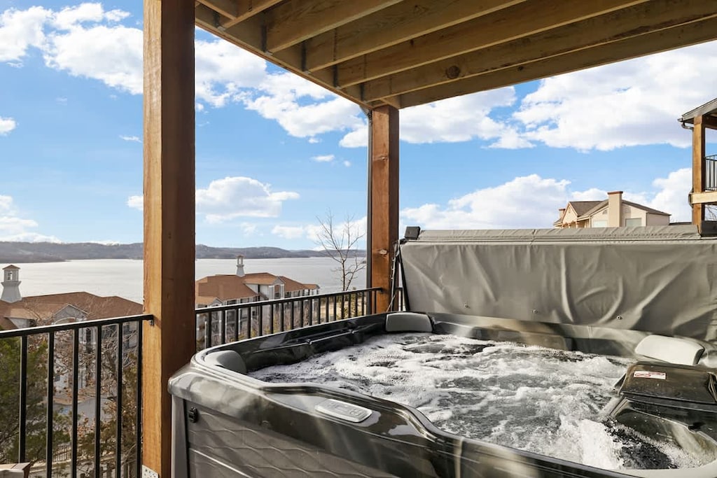 Lower deck with hot tub, seating and lake views