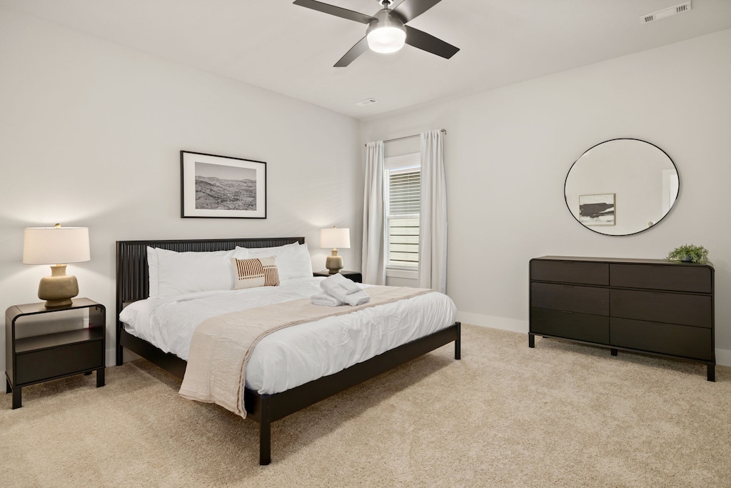 Primary bedroom - King size bed, dresser, walk in closet, and a large, attached bathroom.