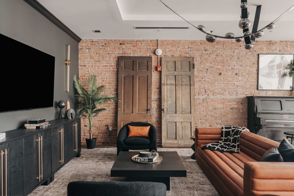 The living room offers stylish and comfortable seating for the whole group, perfect for relaxing or gathering together.