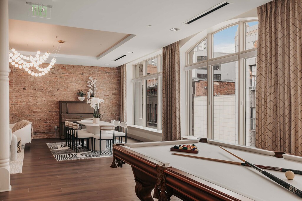 Perched on the top floor, the Bellamy Suite is bathed in natural light, with large windows that illuminate the open-concept living space.