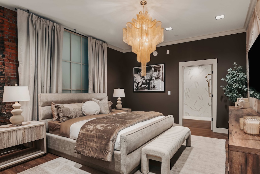 The master bedroom features a spacious king bed dressed in luxurious linens, framed by a striking gold chandelier that adds a touch of opulence to the serene retreat.
