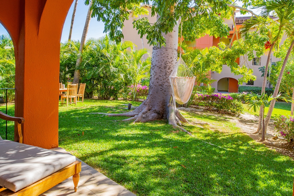 Sunny patio with outdoor seating and hammock