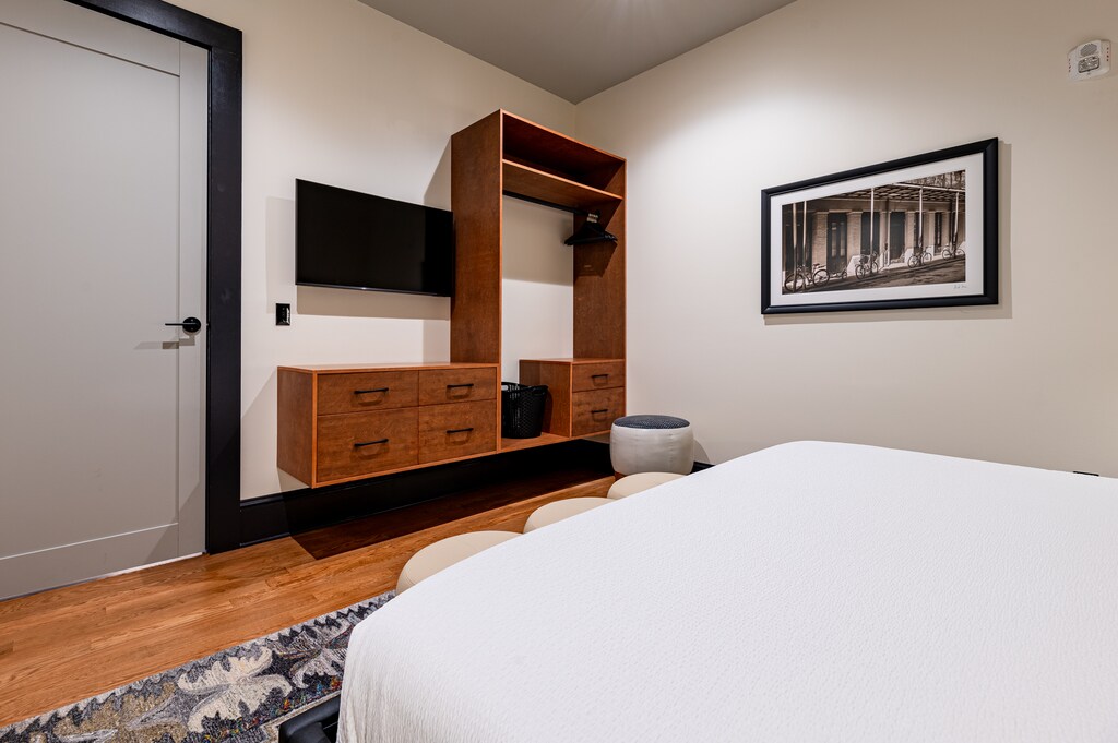 Bedroom 2 - Closet space equipped with hangers, laundry hamper, and iron with ironing board.