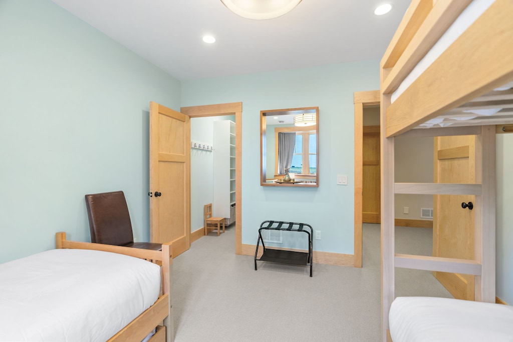 Your spacious room features twin beds and bunk beds, perfect for families or groups seeking comfortable shared accommodation.