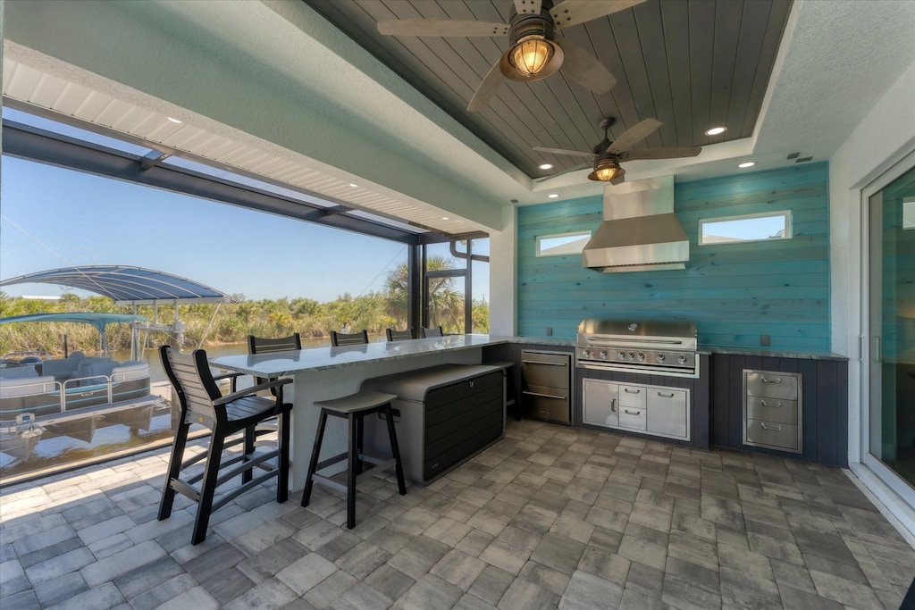 Large lanai overlooking sparkling pool & canal. Lanai features a dining table that seats 10, sun loungers,Smart TV, and a gorgeous outdoor kitchen that includes XL grill, mini fridge, sink, pizza oven and seating for 6 at the island.