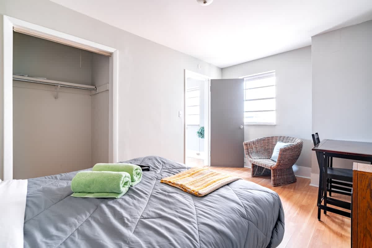dreamy escape in our welcoming bedroom, featuring a luxurious king bed that beckons weary travelers to unwind and rejuvenate. Enhanced by thoughtfully placed lampshades and stylish window coverings, our space offers the perfect sanctuary for vacation