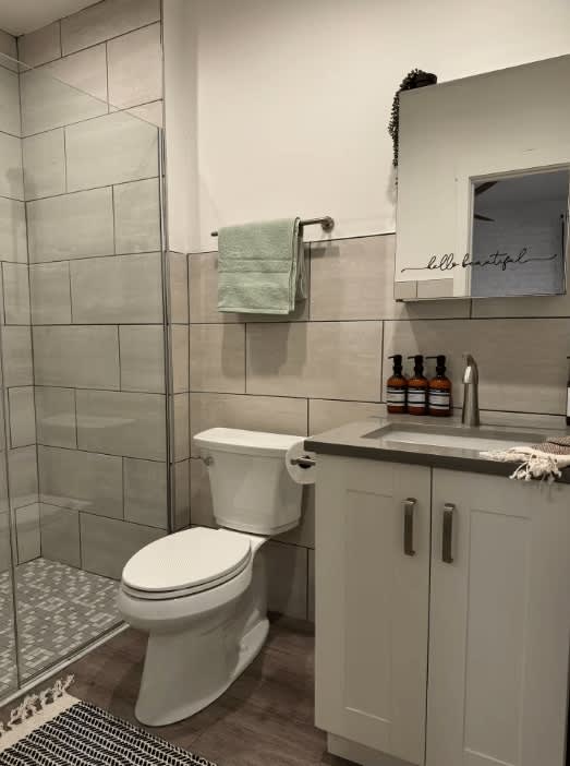 Relax in the elegant bathroom at Russel Masterhouse, where every detail is designed for your comfort. Enjoy a Columbus Airbnb experience that feels like your personal spa retreat! 