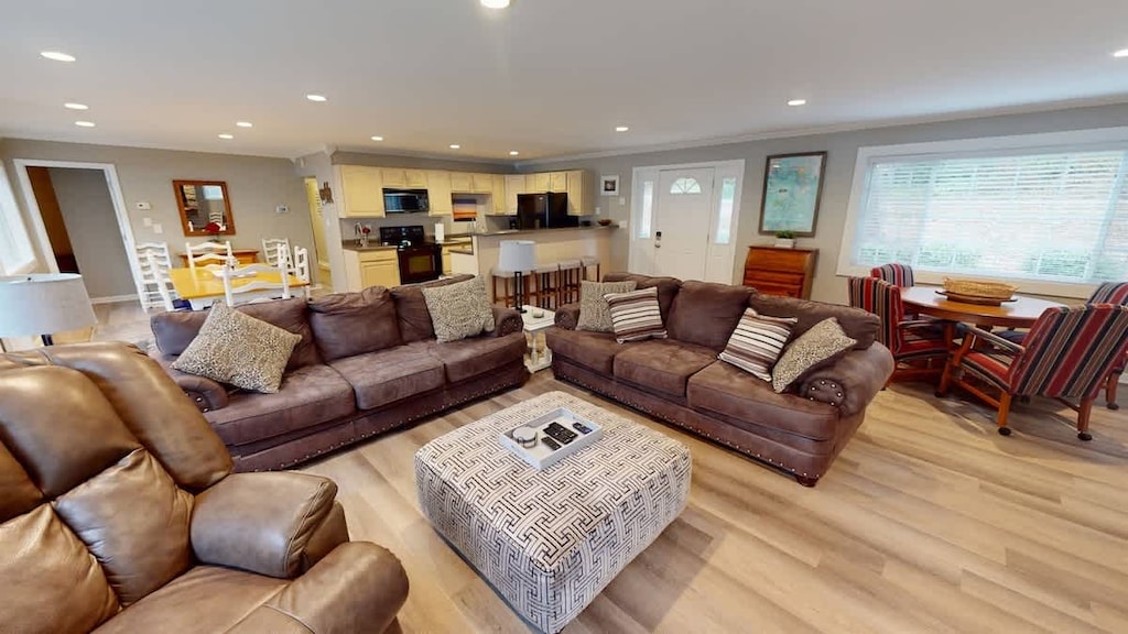 Bright living area with huge couch, fireplace, TV—perfect for movie nights.