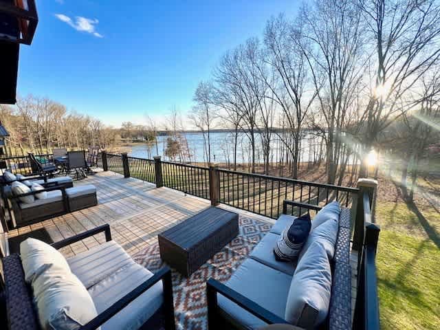 Spacious deck with cozy outdoor seating overlooking a peaceful lake!