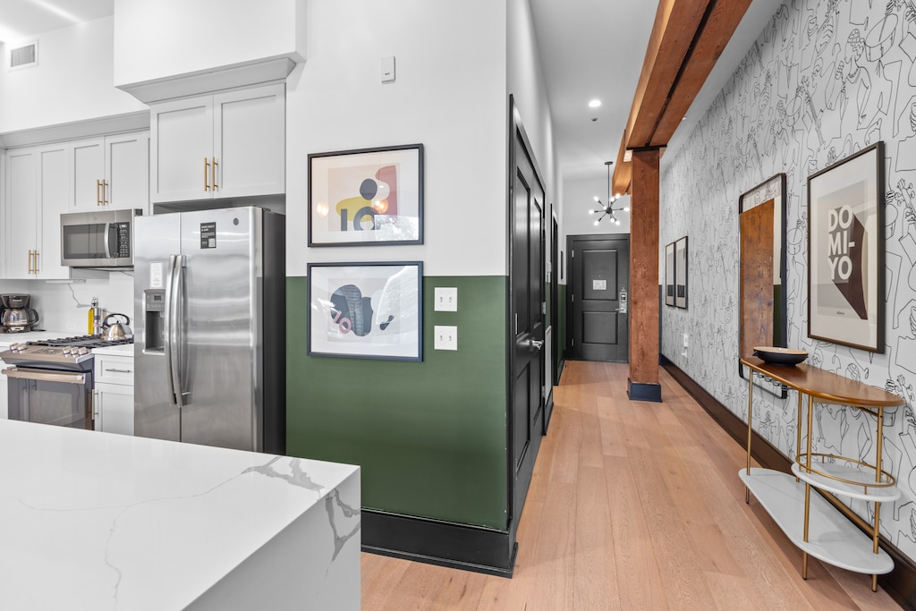 Cook or snack in style with a full kitchen featuring GE stainless appliances, cookware, and an island with bar seating. Ideal for short or extended stays, our kitchens make group travel in New Orleans easy and comfortable.