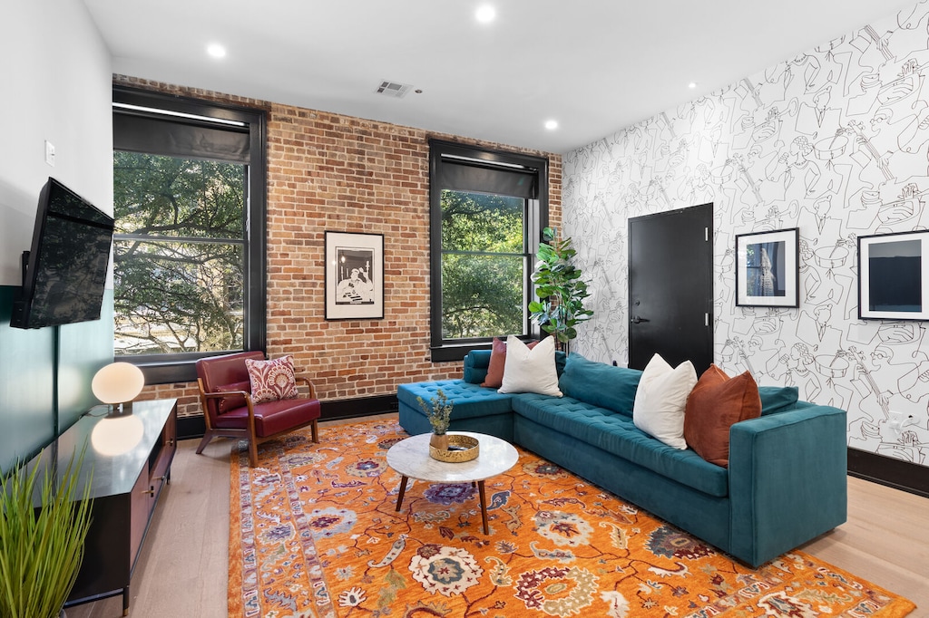Relax in the living area with a smart TV, stylish seating, and a sleeper sofa for extra guests. Perfect for families or group stays in New Orleans, this inviting space is ideal for movie nights or recharging after a day in the city.
