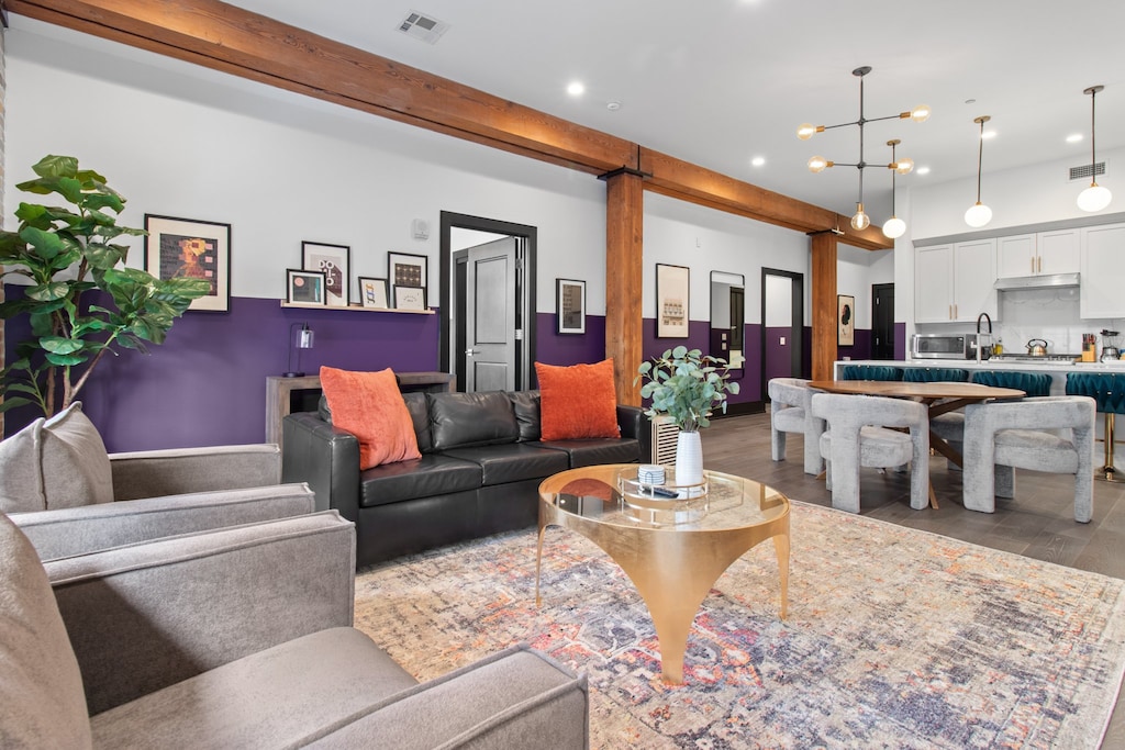 Relax in the living area with a smart TV, stylish seating, and a sleeper sofa for extra guests. Perfect for families or group stays in New Orleans, this inviting space is ideal for movie nights or recharging after a day in the city.