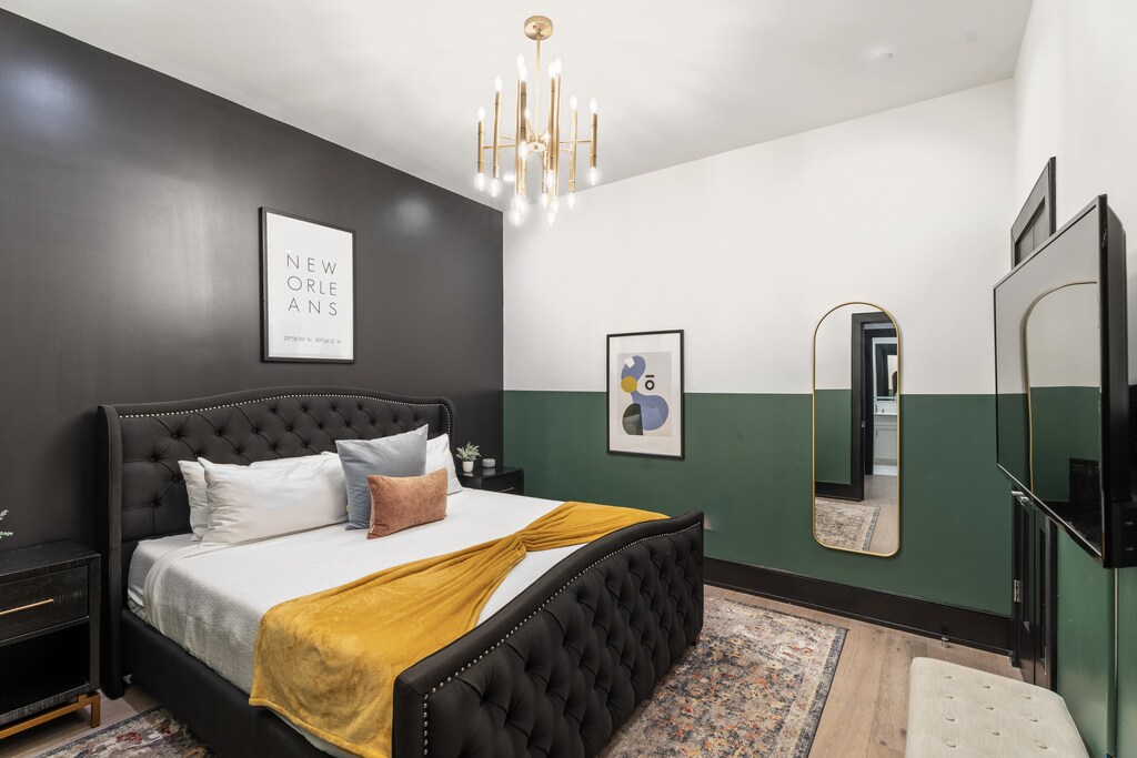 Retreat to the primary bedroom with a plush king bed, walk-in closet, blackout shades, and a smart TV. Designed for comfort and privacy, this suite is perfect for recharging after a day exploring New Orleans.