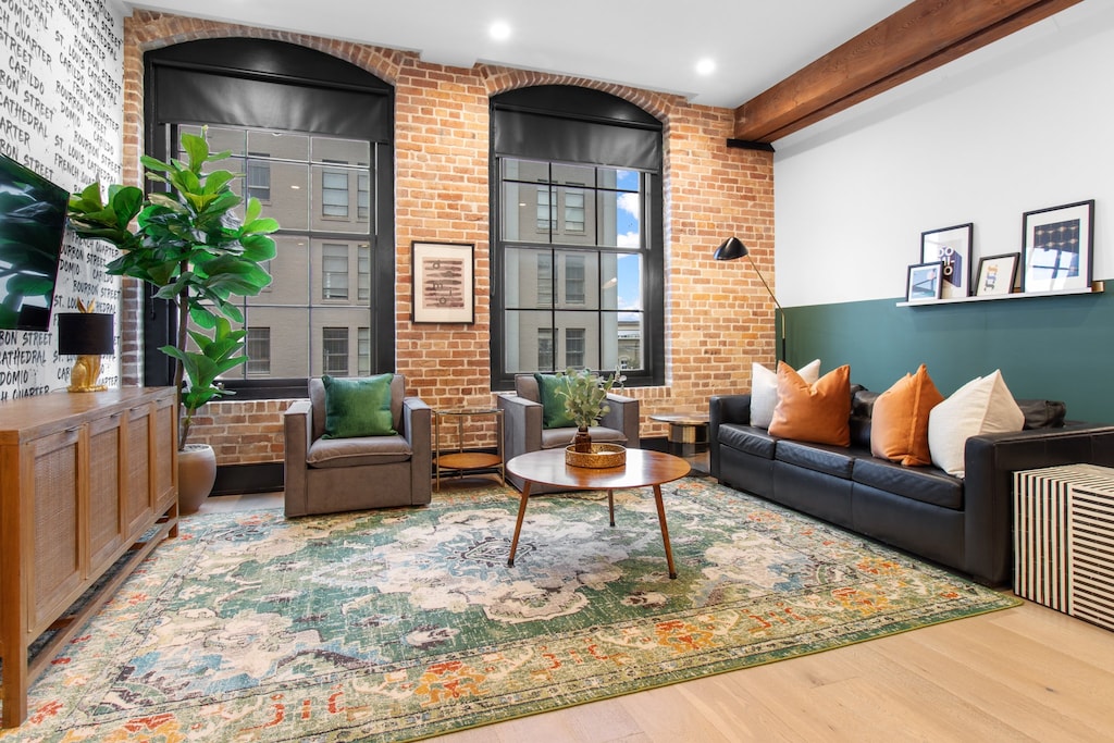 Relax in the living area with a smart TV, stylish seating, and a sleeper sofa for extra guests. Perfect for families or group stays in New Orleans, this inviting space is ideal for movie nights or recharging after a day in the city.