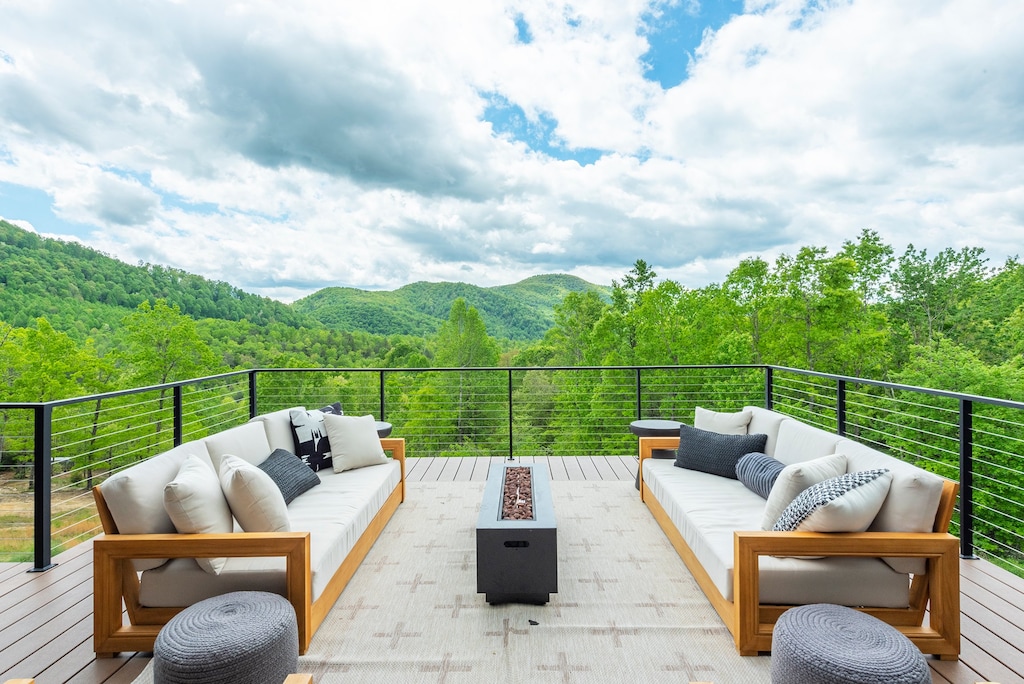 Enjoy panoramic views around the gas fire table and outdoor dining area on the deck.