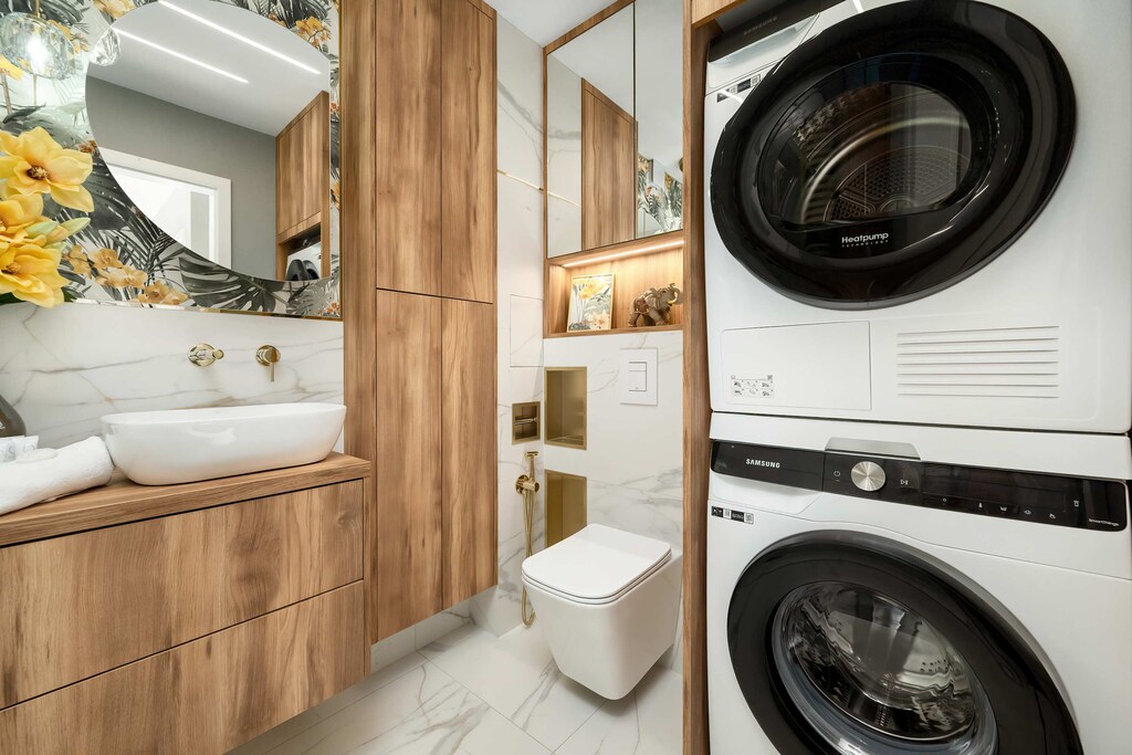 A bathroom with a washer-dryer and shower cabin offers convenience for longer stays and family trips.