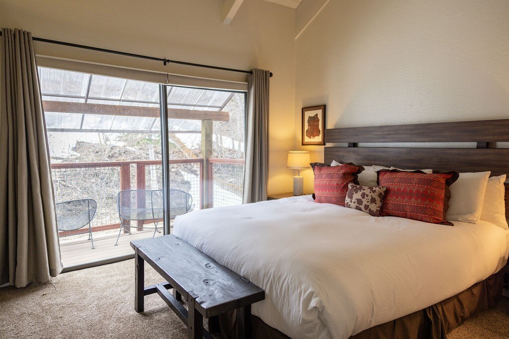 Enjoy the deck from this lovely master bedroom