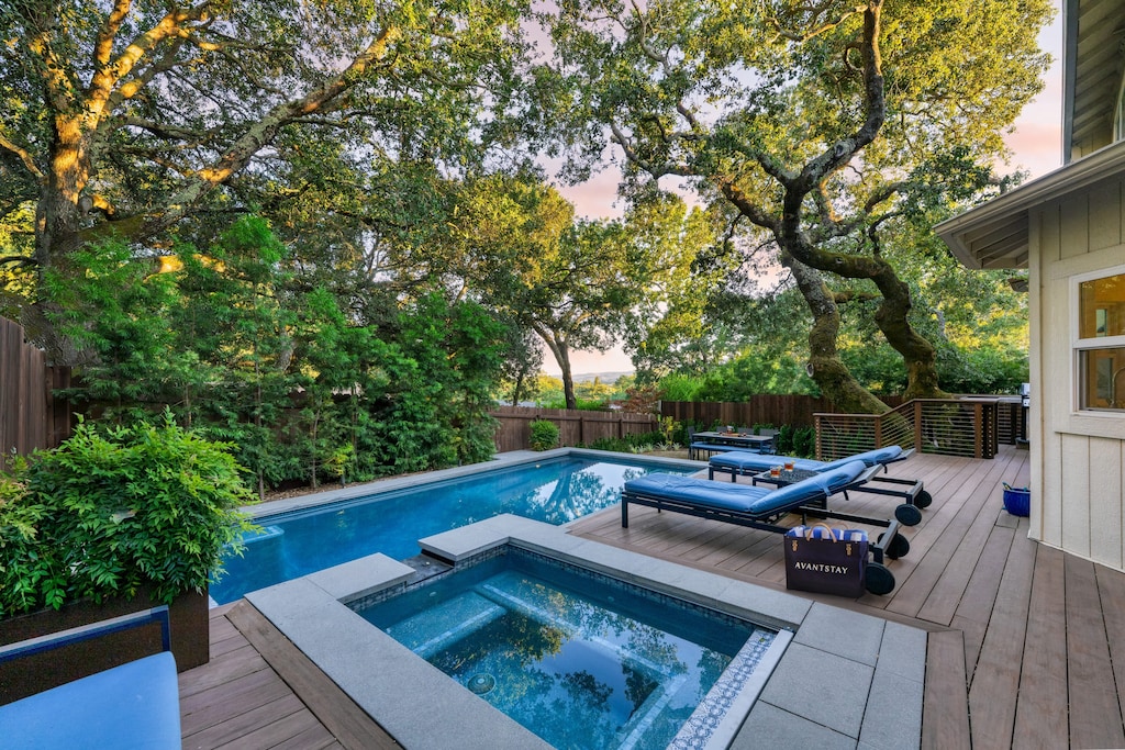 Relax and unwind in the serene pool and spa in the private backyard.