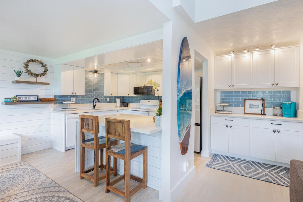 Fully stocked kitchen with quartz island and stainless appliances for effortless cooking.