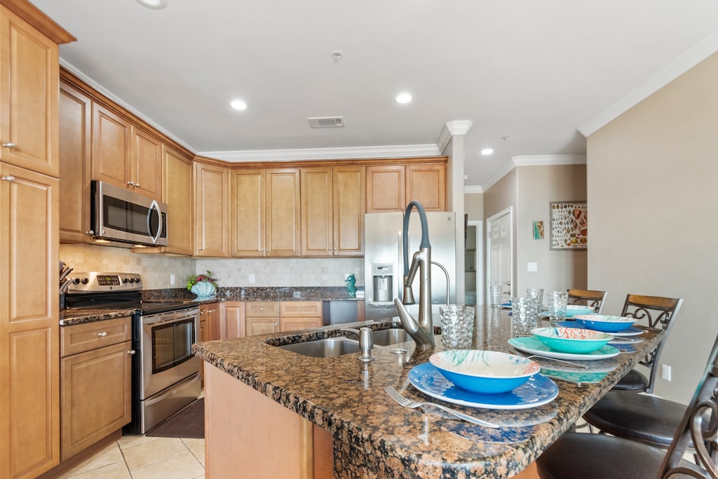 Open kitchen with breakfast bar seating, SS and granite