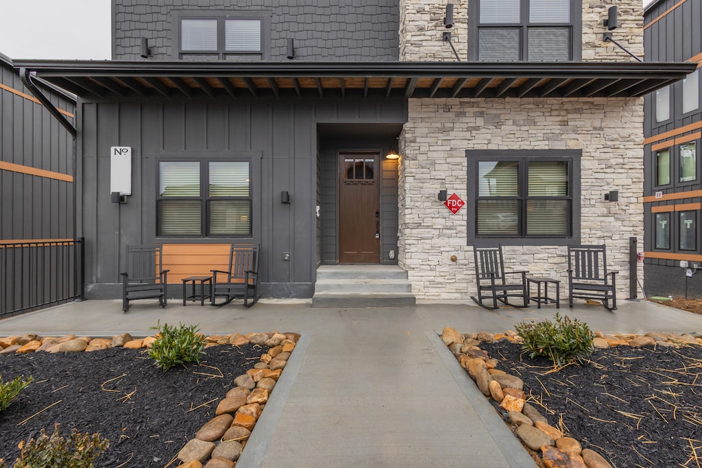 The front view of a modern suburban home, with a well-maintained yard and driveway leading up to the garage. The house has a minimalist design with a combination of modern materials like wood and metal.