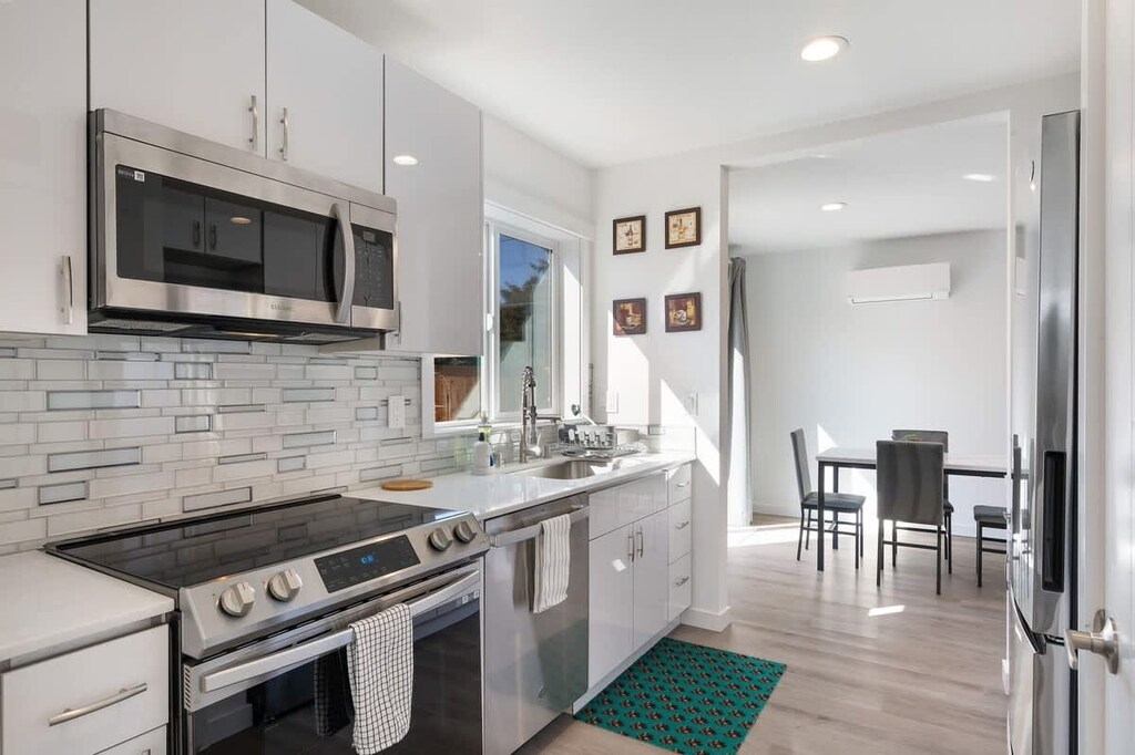 Cook dinner or heat up leftovers—kitchen includes full-size stove and modern layout.