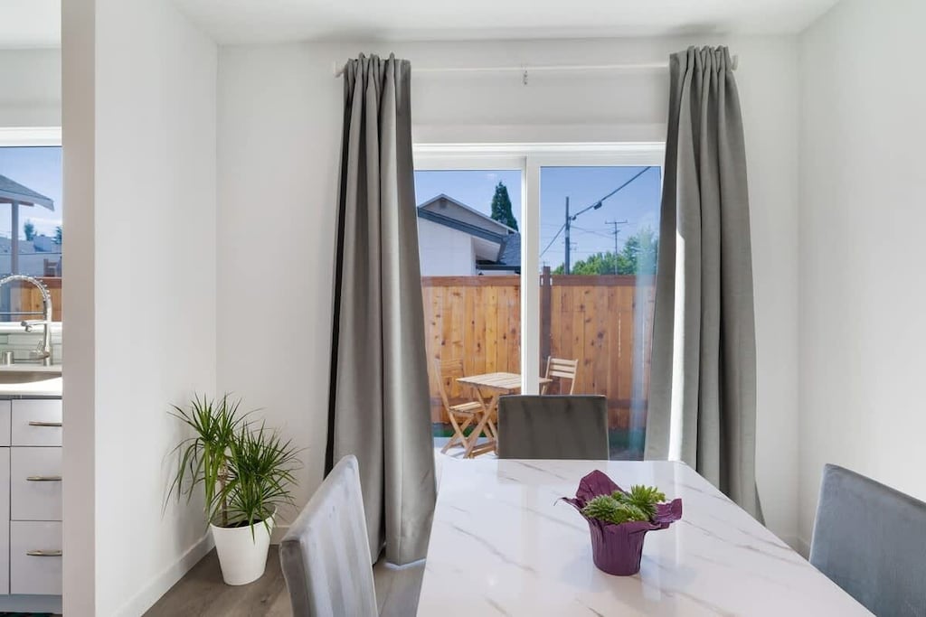 Sit down for meals or set up a laptop—dining area opens onto the fenced backyard.