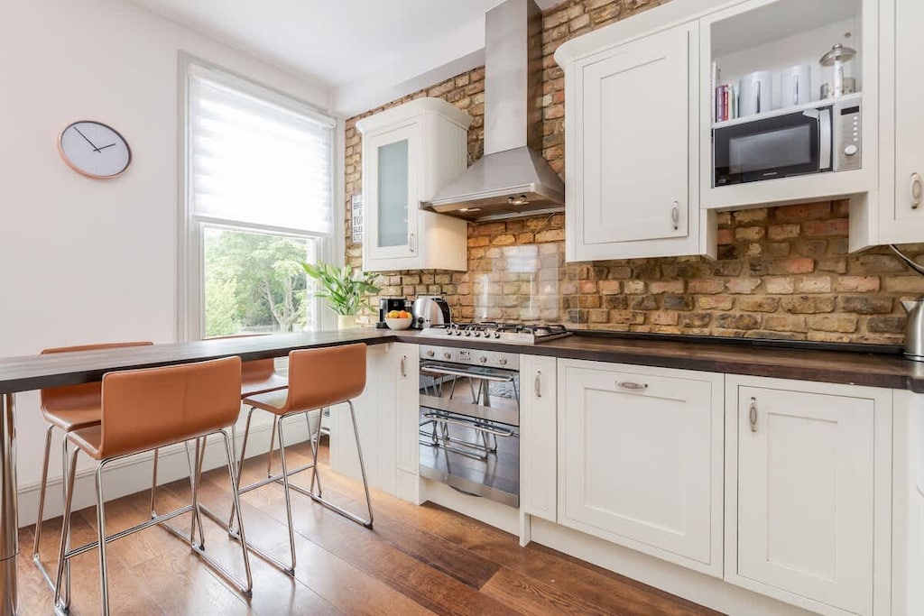 Kitchen is fully equipped and with modern appliances. It has a wooden breakfast bar where you can enjoy your meals and socialise