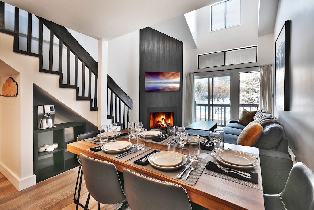Dining room table overlooking the wood burning fireplace and living room