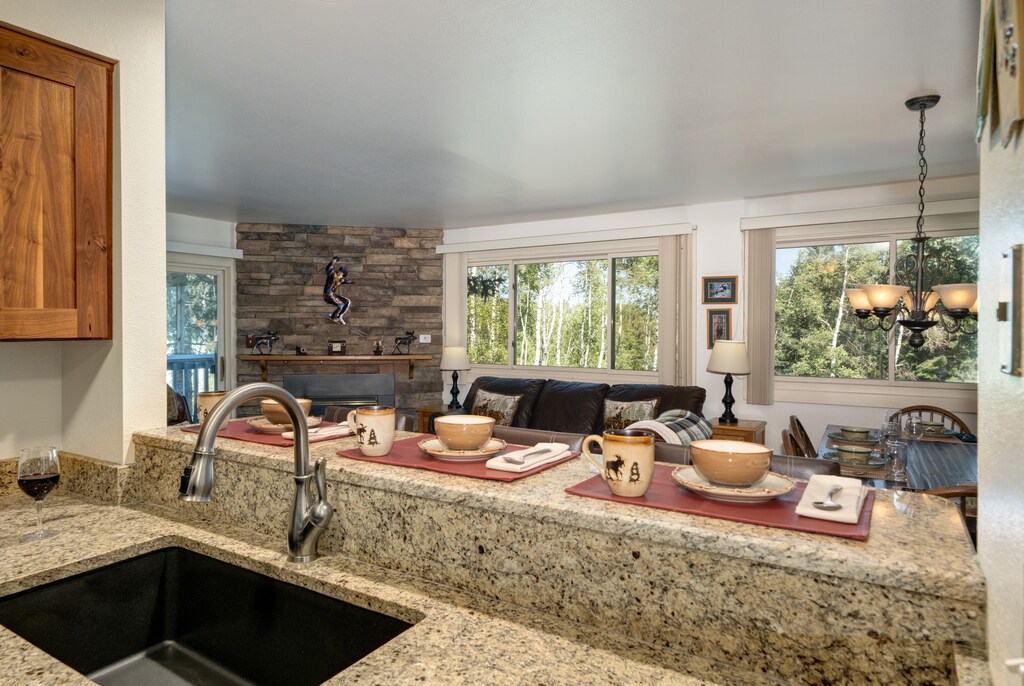 The kitchen breakfast bar offers seating and place settings for three guests.