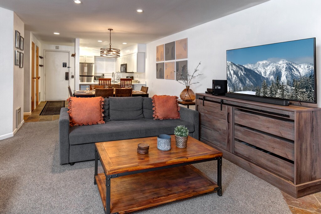 The living room has comfortable couches and flat screen TV.