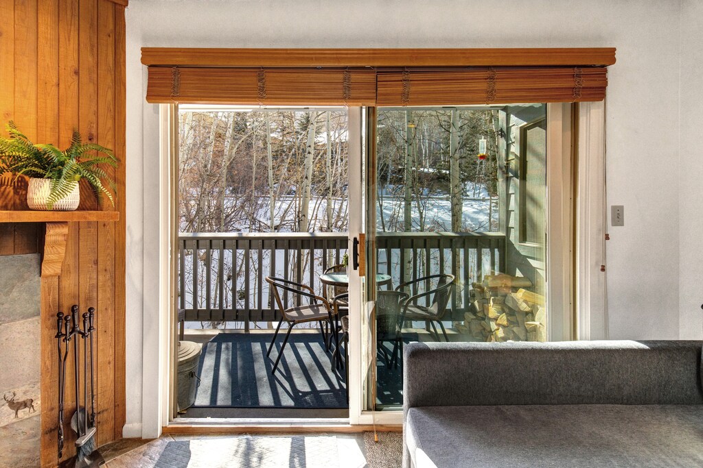 The living room has comfortable couches and views of the aspen grove.