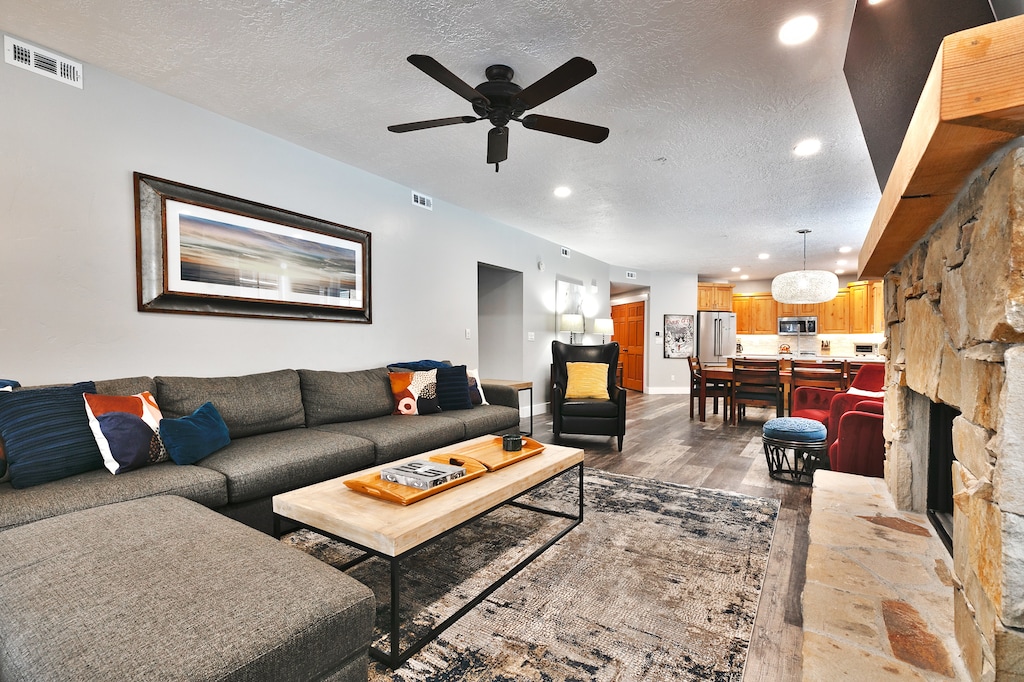 Gray tweed sectional couch in the living room with solid wood coffee table