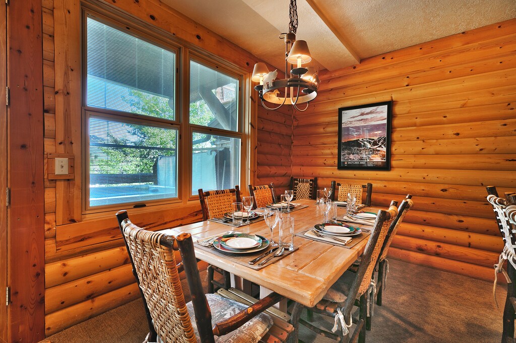 Solid wood dining table in the first dining room, seating for 6 in high back log wood chairs