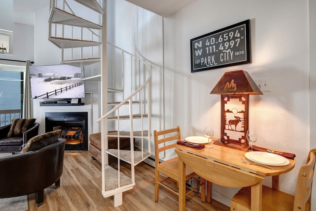 Settle into your cozy mountain retreat with rustic charm - dine by lamplight at your intimate wooden table while the fireplace creates the perfect après-ski ambiance.