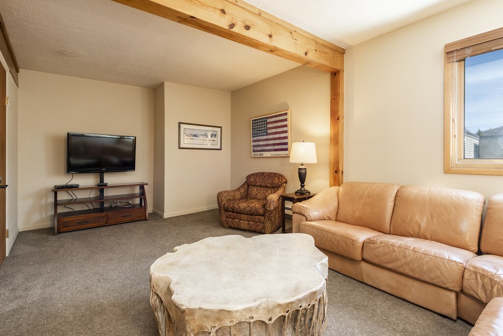 Loft area features comfortable seating and a wall-mounted flat screen