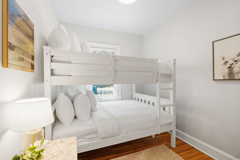 Cozy bunk bed room with soft linens and cheerful décor creates the perfect space for kids or friends to share.