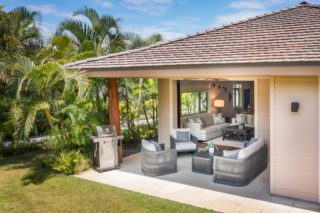 Enjoy seamless indoor-outdoor living with this shaded lanai and private yard—ideal for family gatherings or relaxing after a day at the beach.
