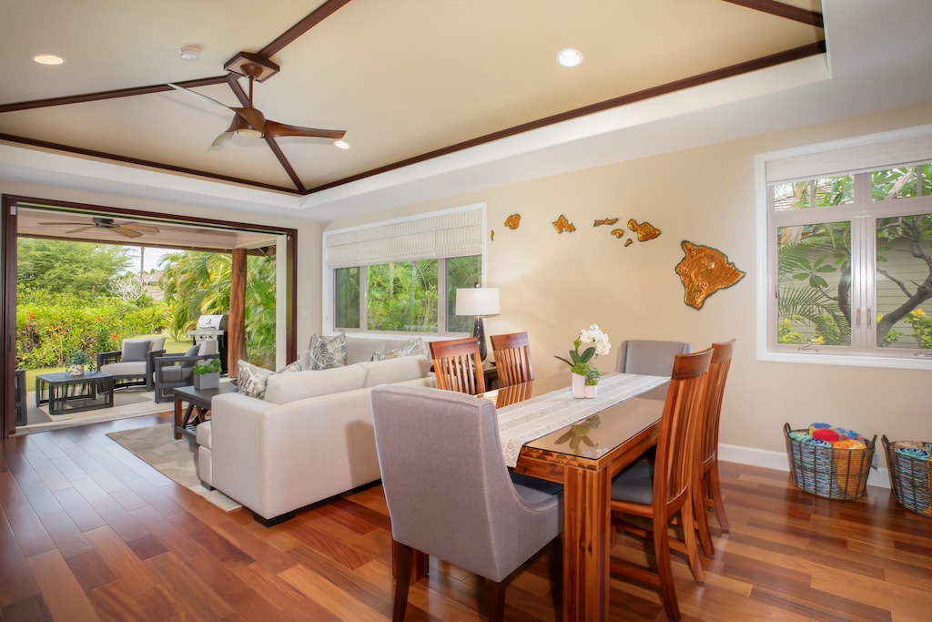 The airy great room brings everyone together for meals, games, or movie nights in true Hawaiian comfort.
