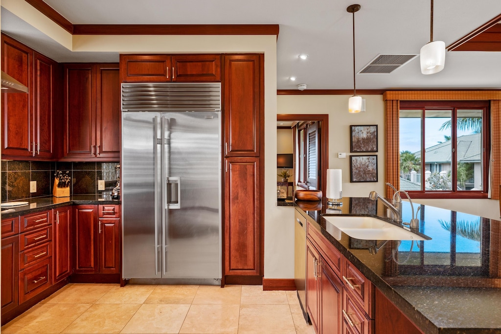 The kitchen features subzero refrigerator