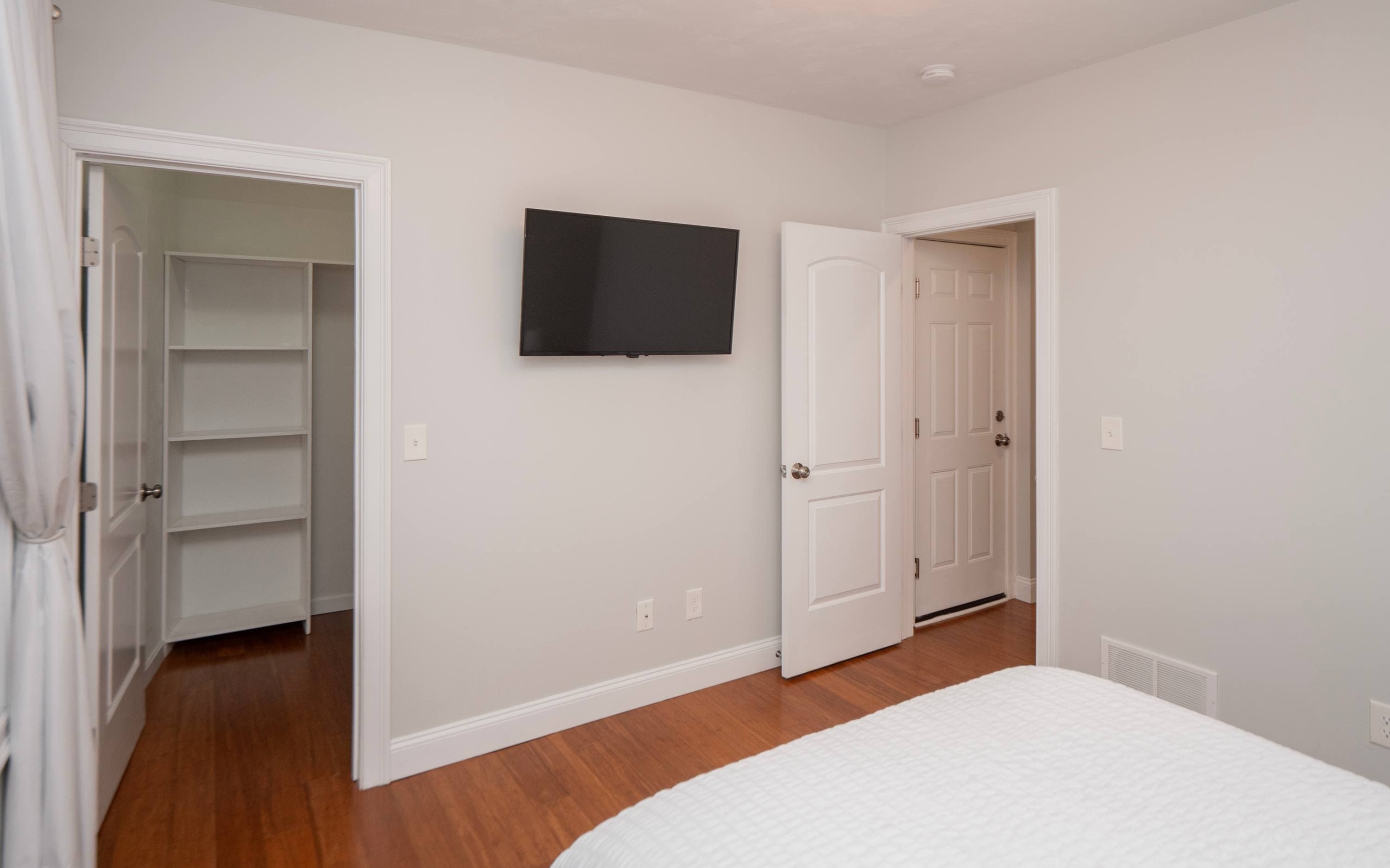 Bedroom has a walk-in closet and a TV