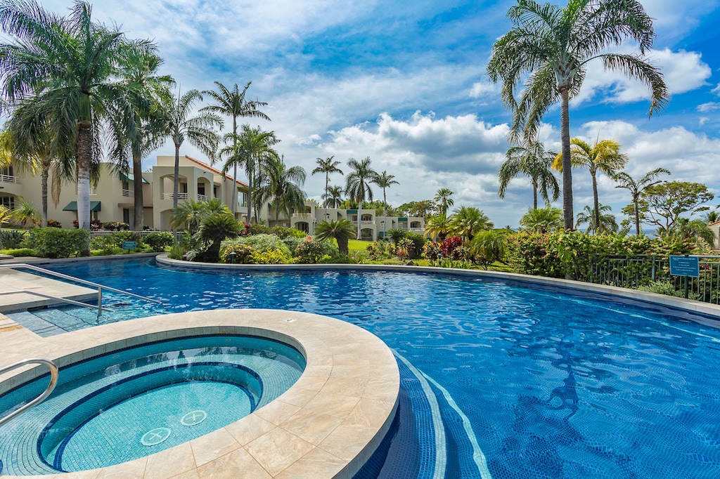 Luxurious pool and hot tub on property